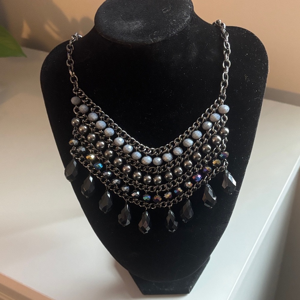 Unique statement necklace with Black chain.
Gray/black beads.